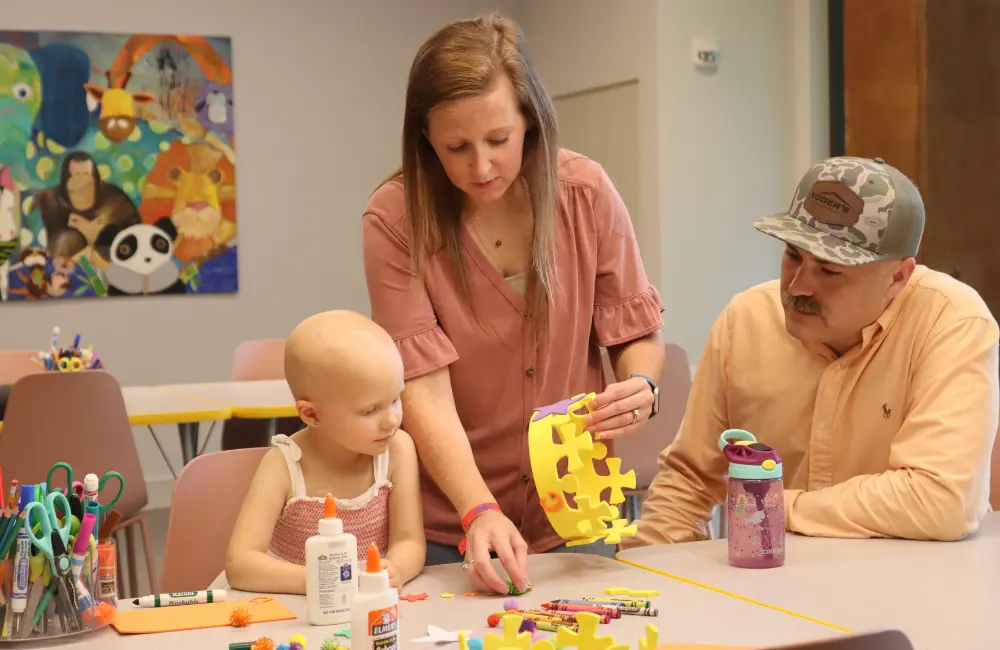 parents and girl doing crafts