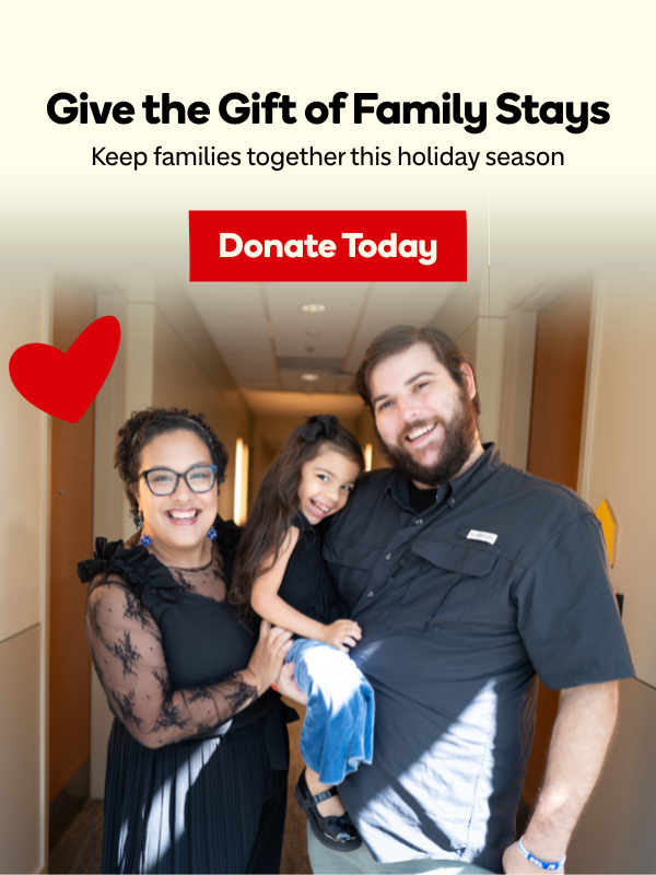 woman and man holding girl smiling