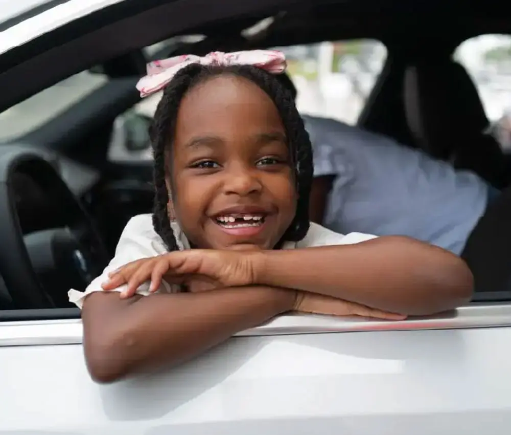 girl smiling in car window