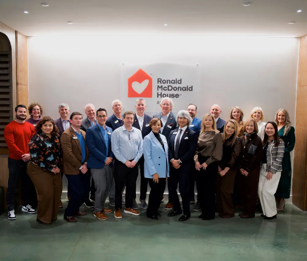 group of people standing in front of sign