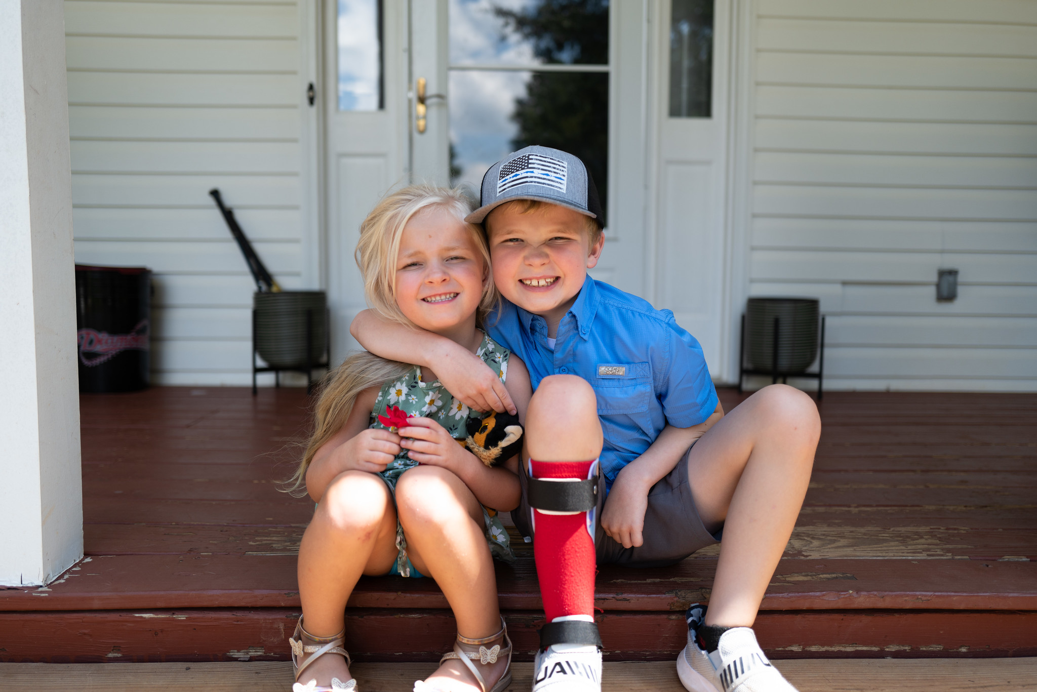 boy hugging girl on porch