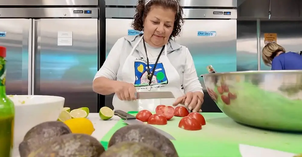 woman cutting vegetables in kitchen
