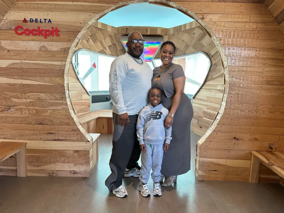 man, woman, and boy standing smiling