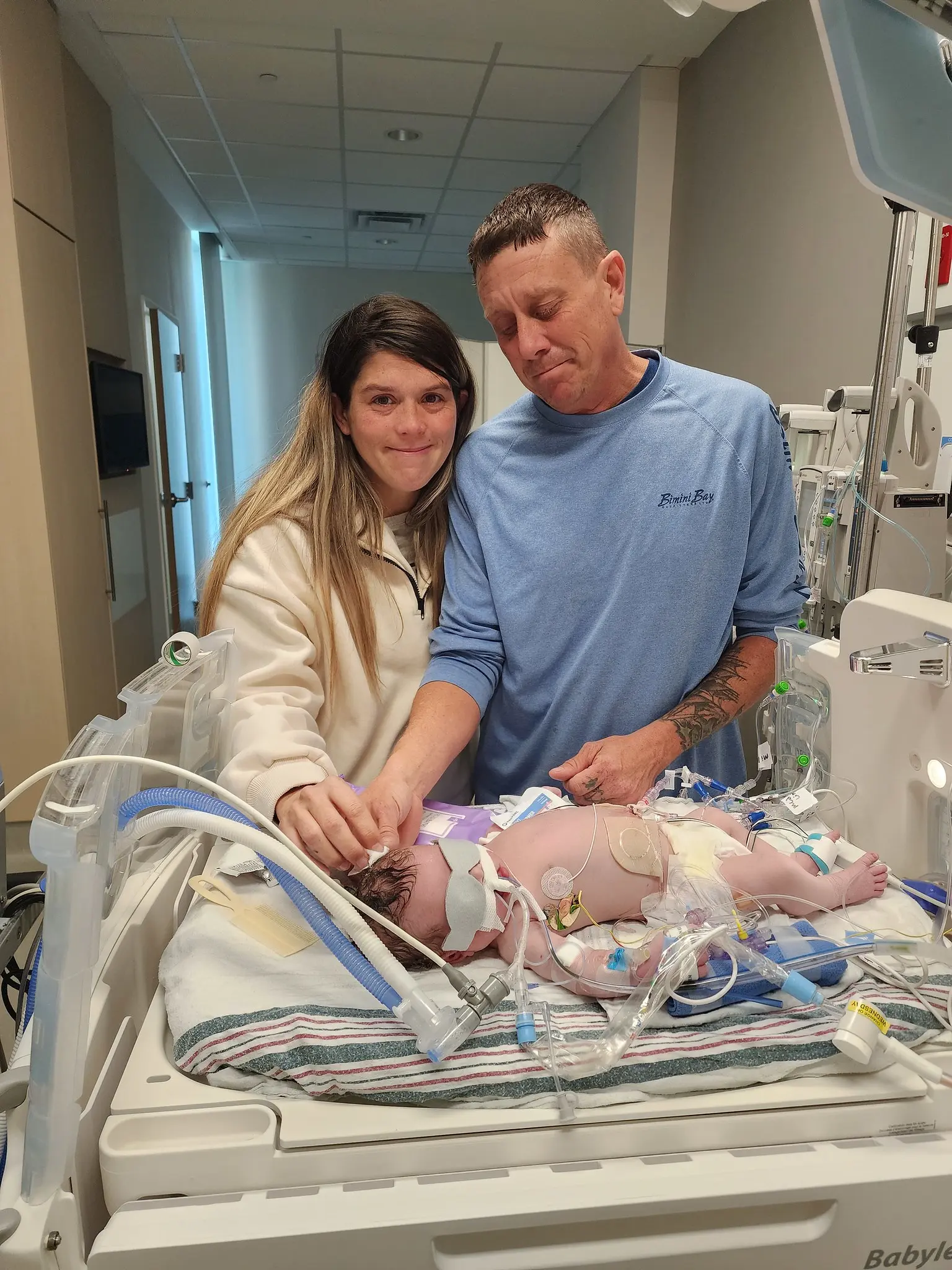 woman and man with baby in hospital