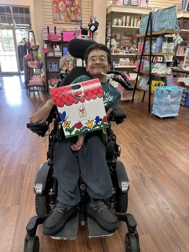 boy holding pop tab box