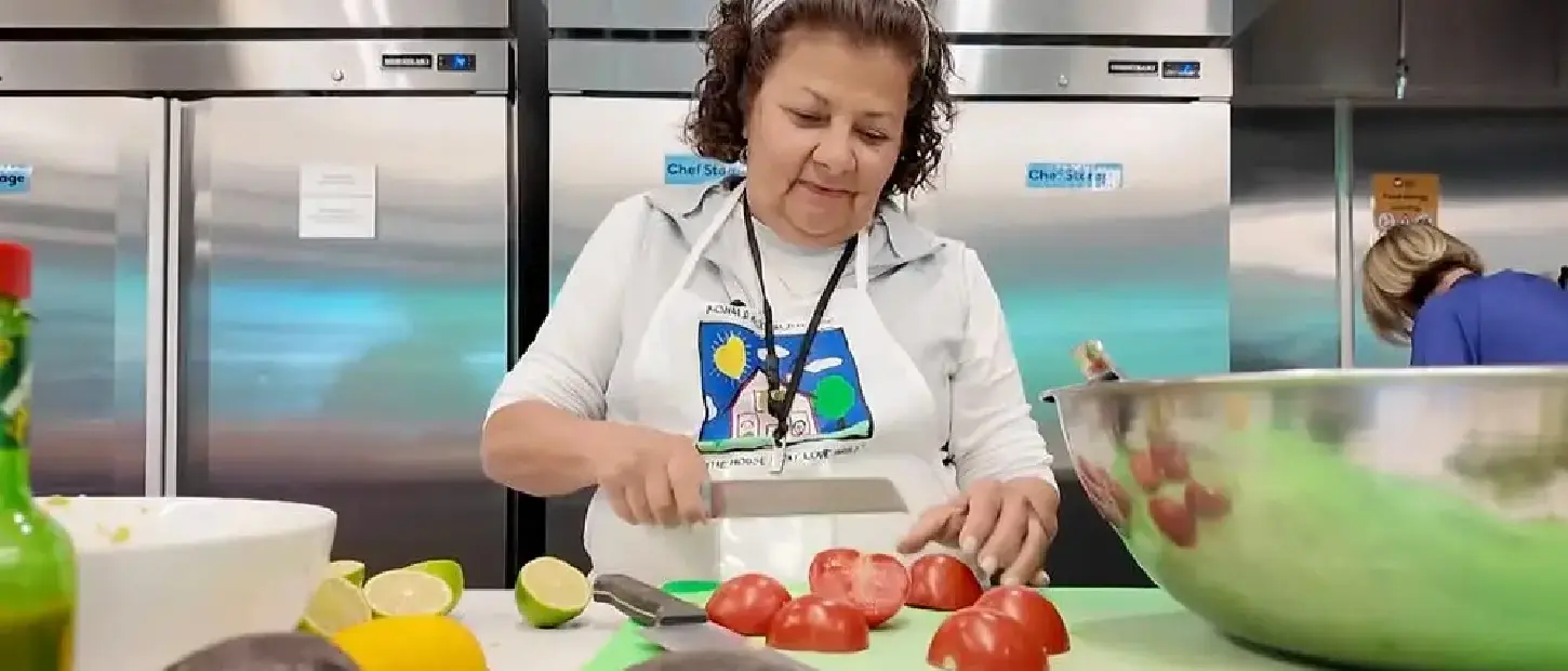 woman cutting vegetables in kitchen