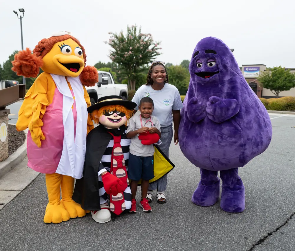 boy and woman standing next to McDonalds characters