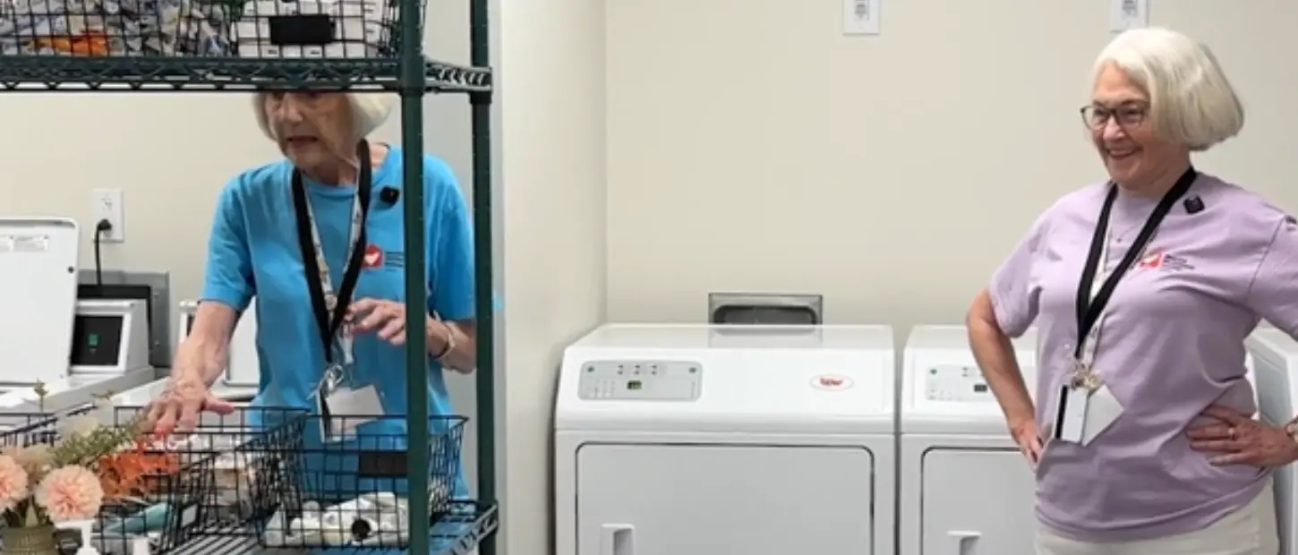 two women standing in laundry room