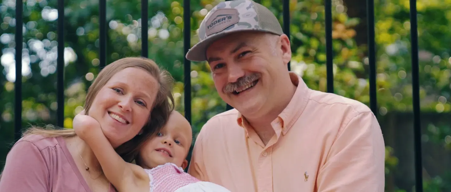 girl hugging parents smiling