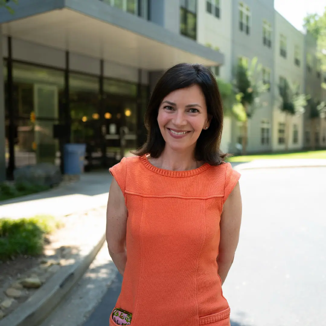 woman smiling in front of building