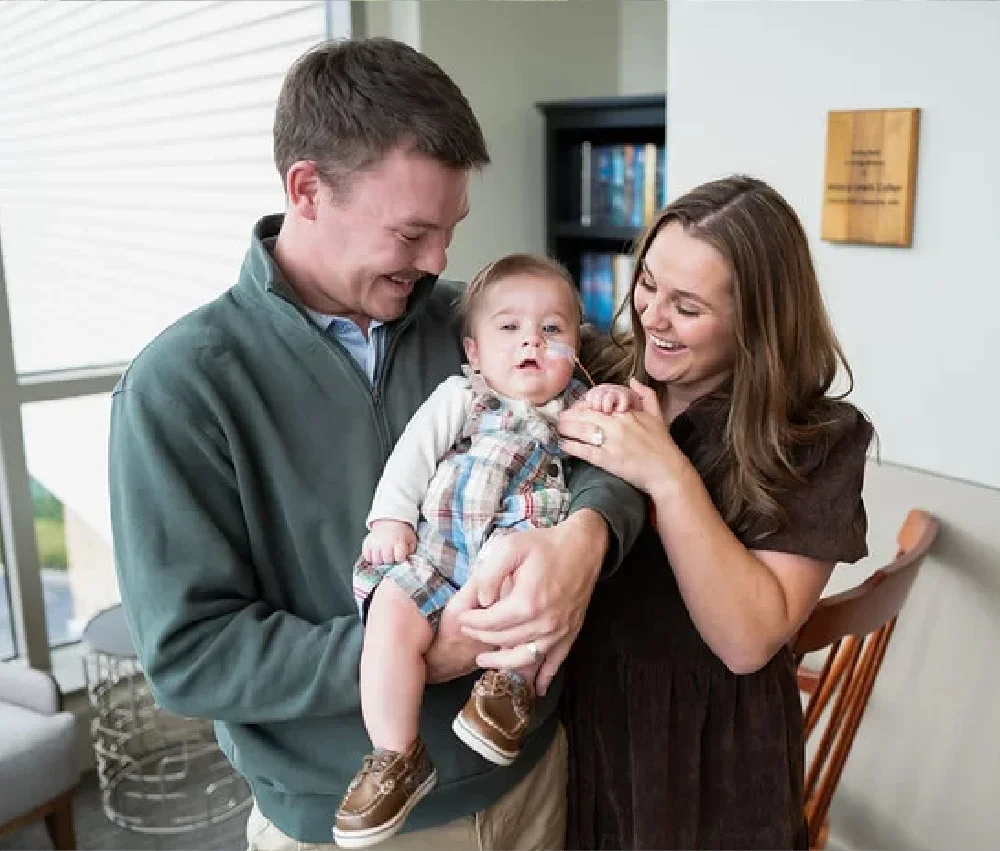 parents holding baby boy