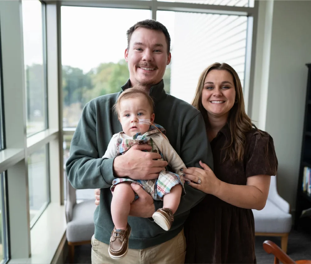 man and woman holding baby boy