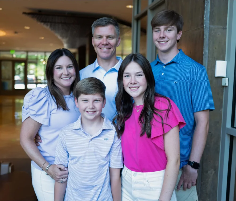 family with mother father and three children smiling
