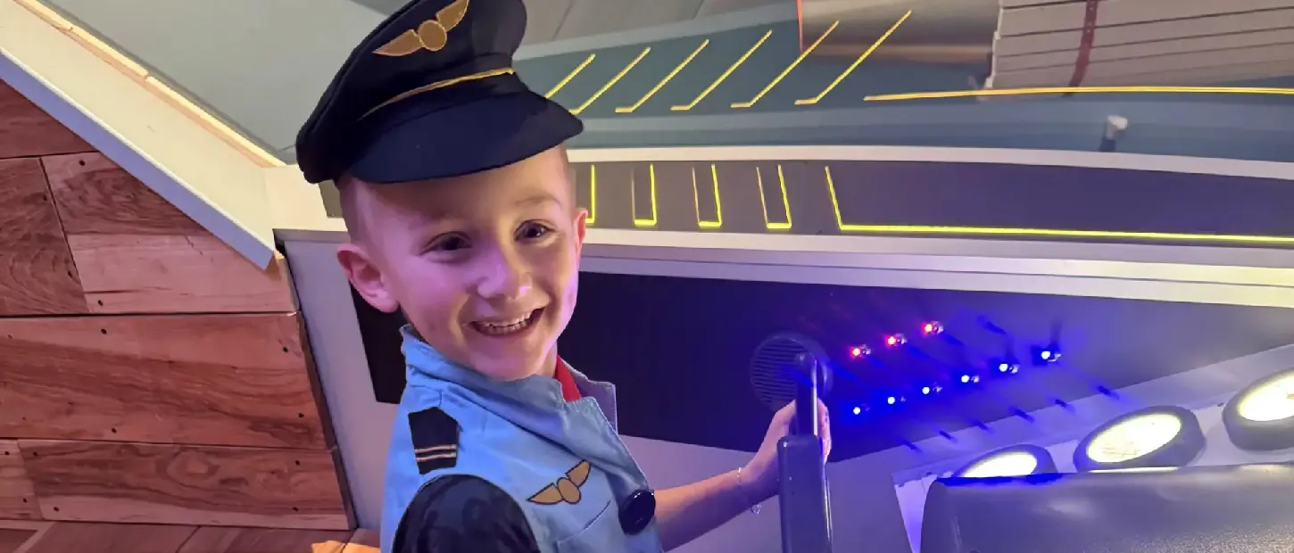 boy flying fake airplane