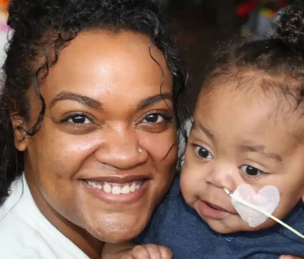 woman smiling holding baby