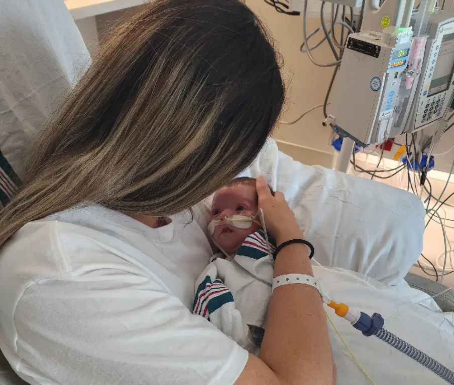 mom holding baby