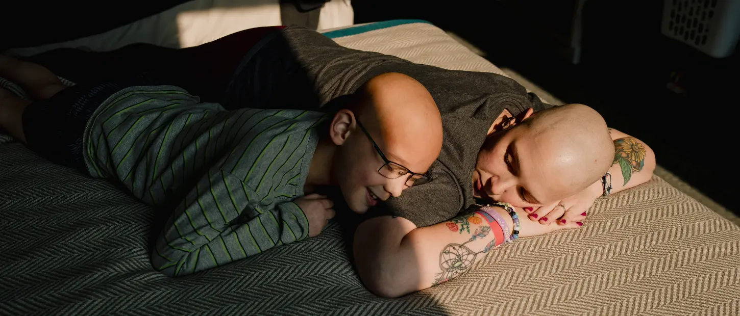 woman and boy laying on bed