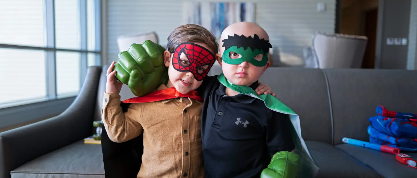 two boys hugging in costumes