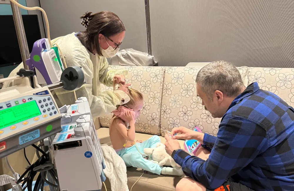 girl in hospital with doctor and man