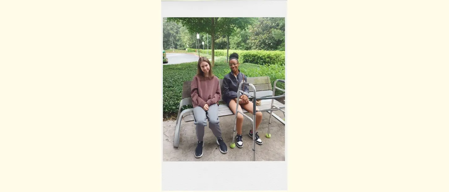 two girls sitting on a bench