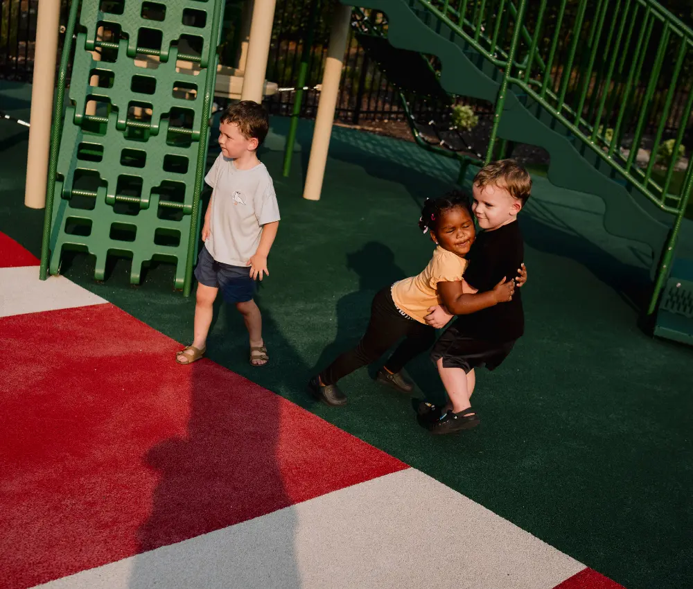 kids hugging on playground