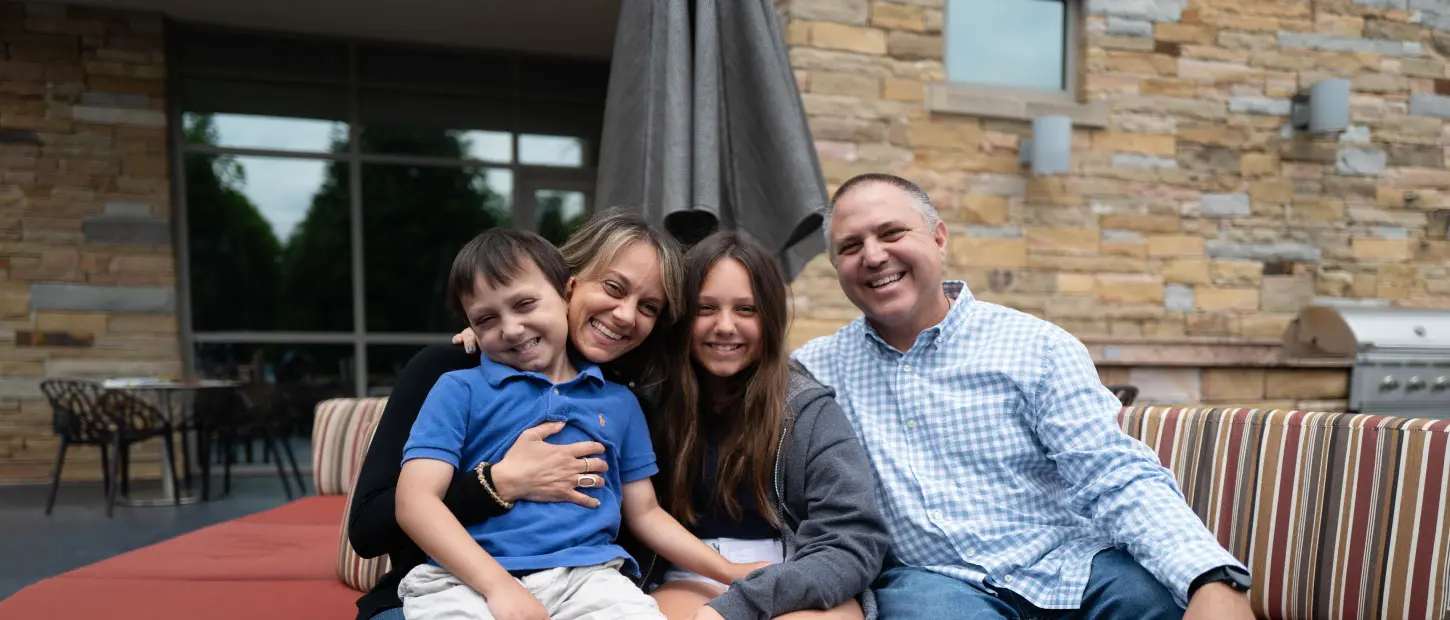 family sitting on couch smiling