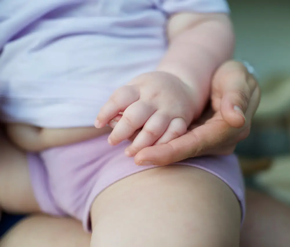 babys hand in womans hand