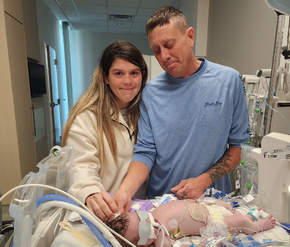 woman and man with baby in hospital